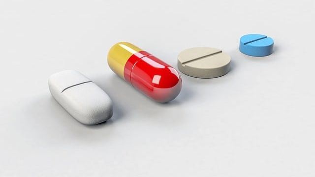 Four drug tablets lined up. 